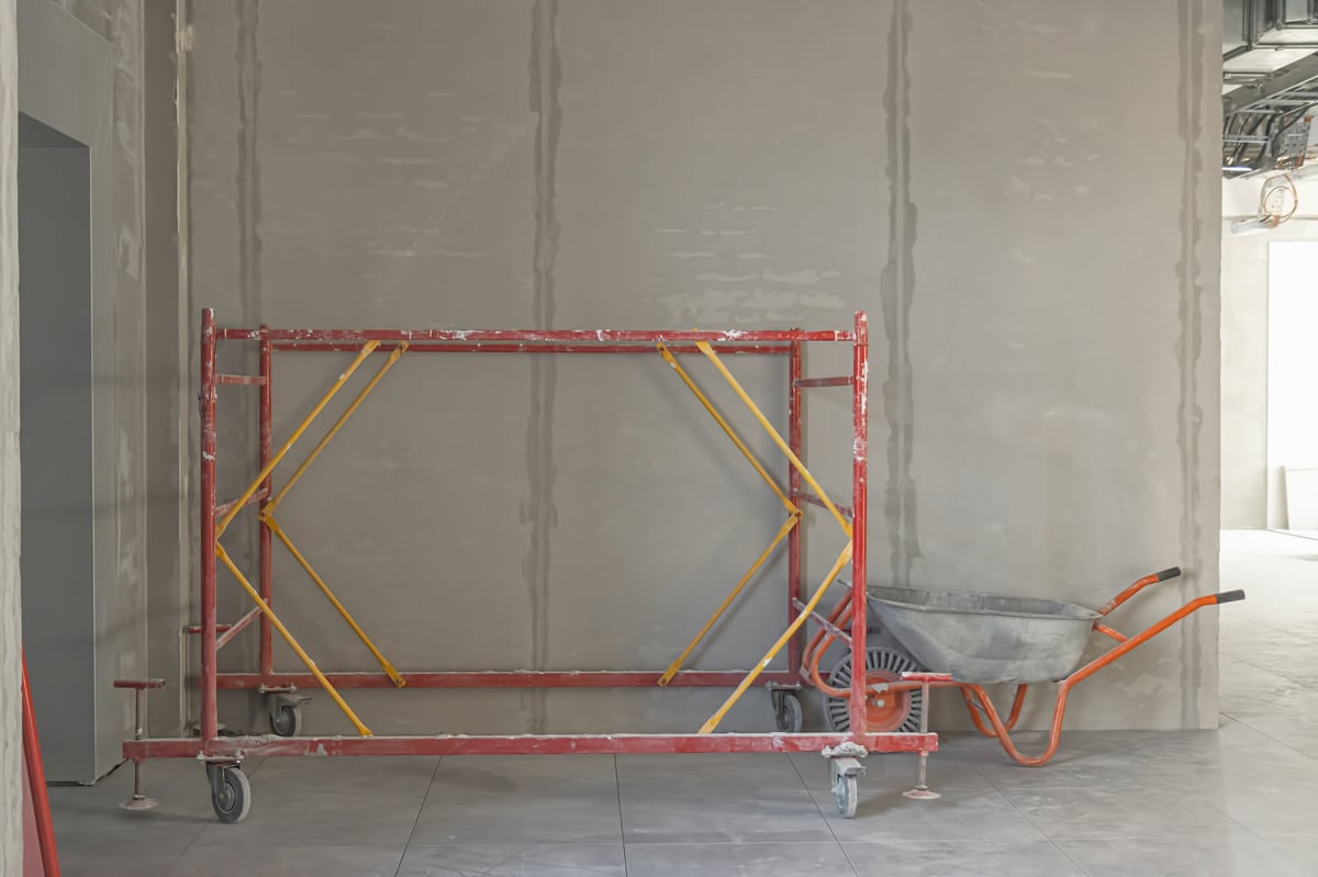 Building renovation in progress with scaffolding and equipment